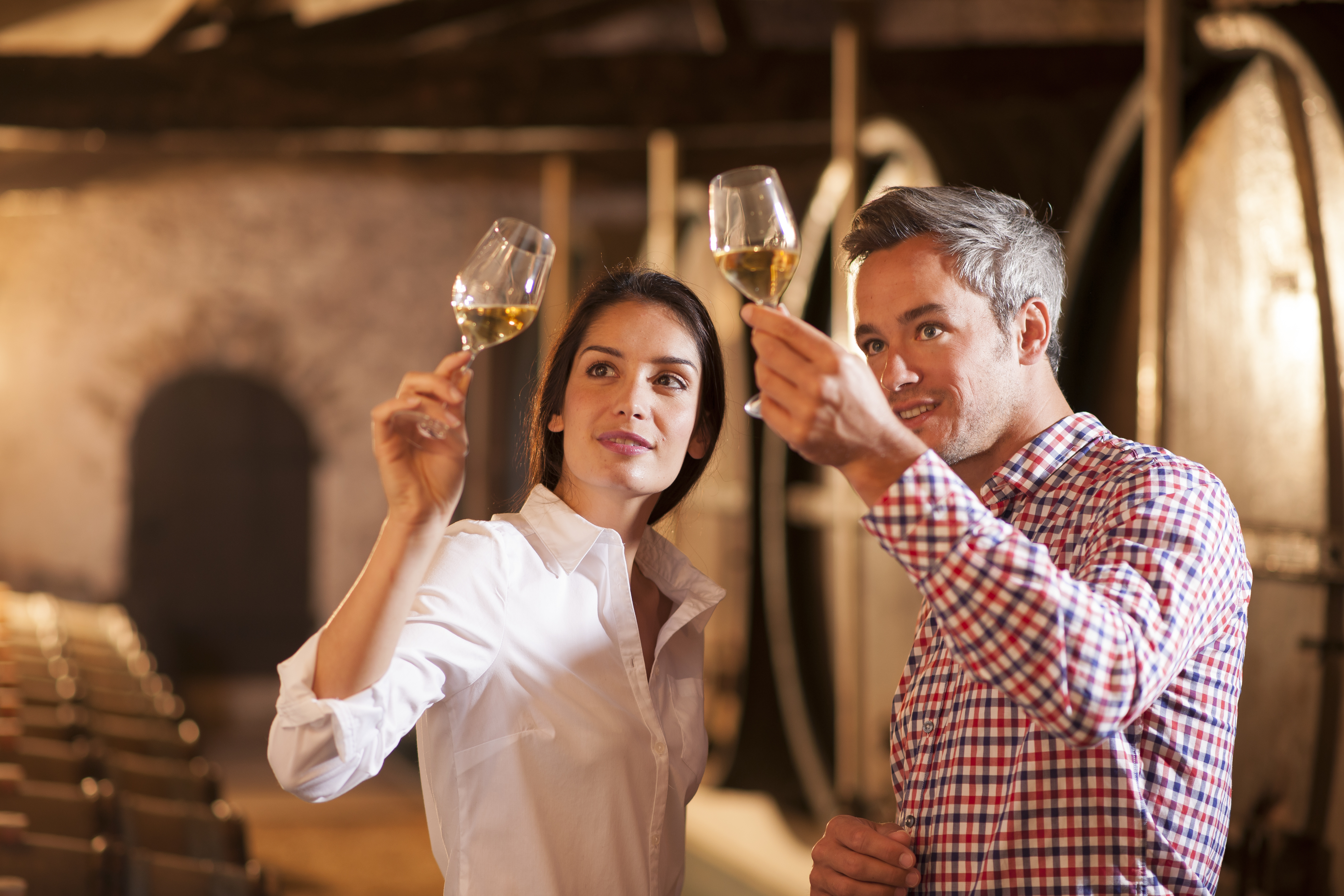 couple-tasting-glass-of-wine-in-cellar