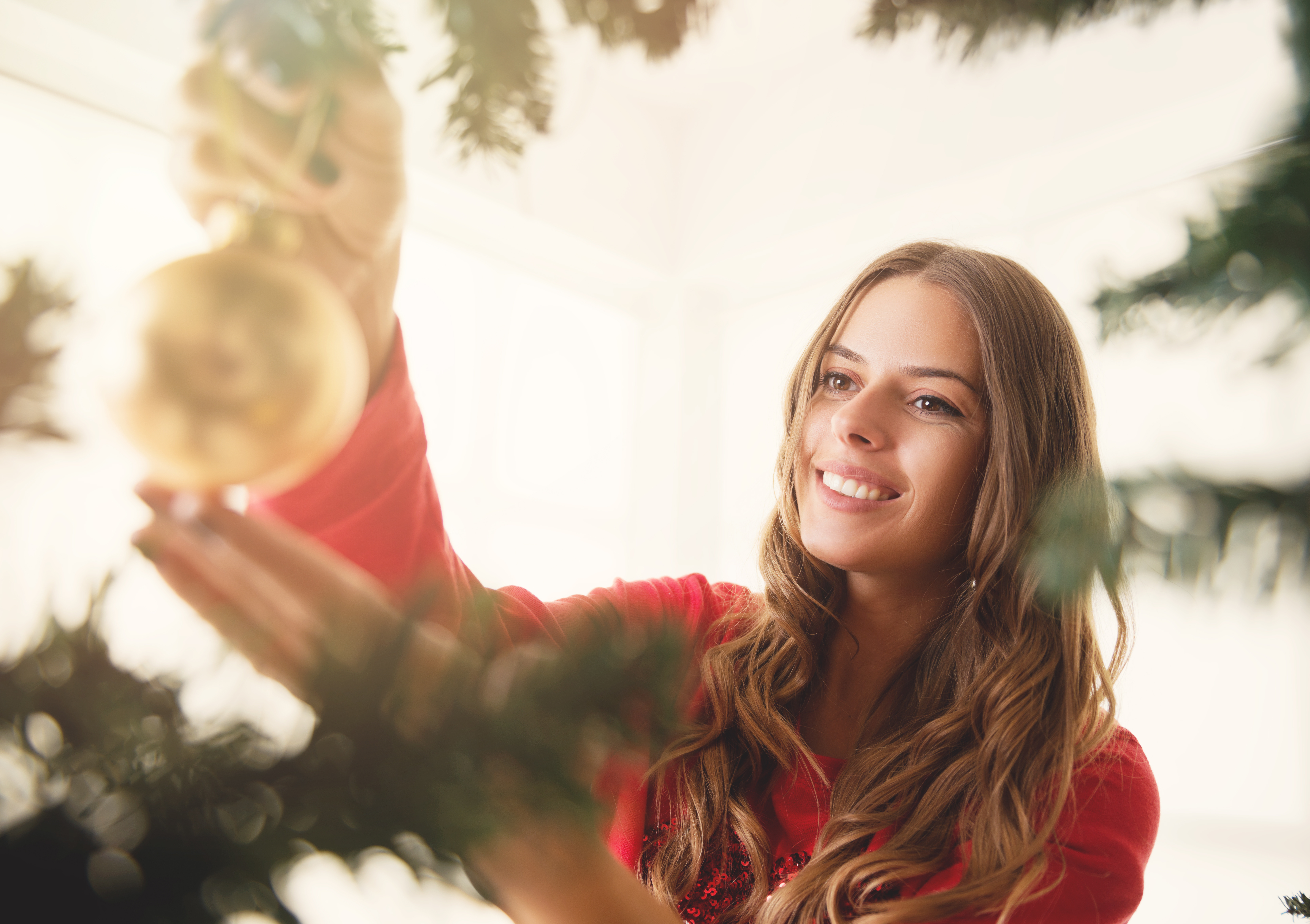 young-woman-decorating-Christmas-tree