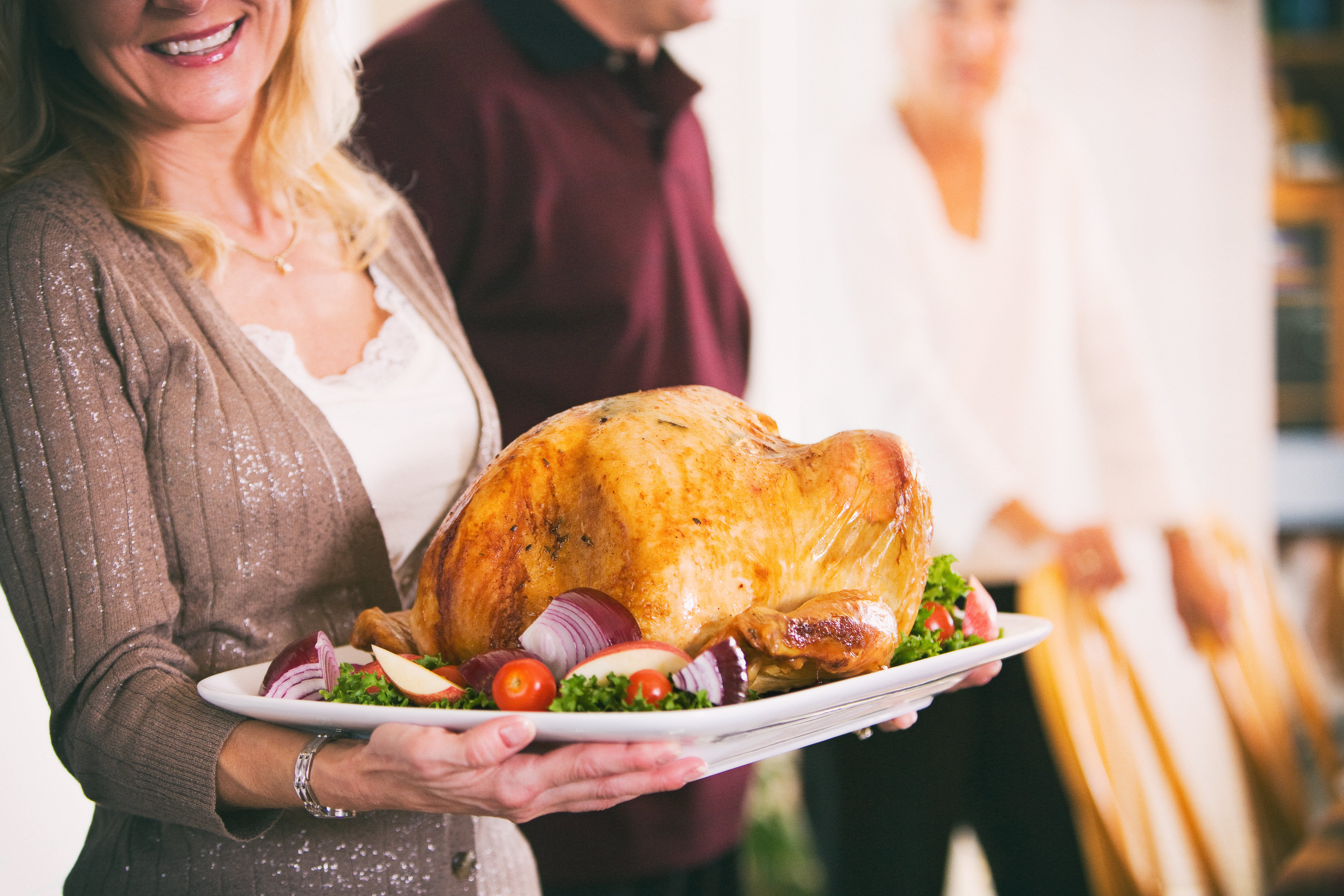 Thanksgiving-woman-holding-turkey-with-garnish